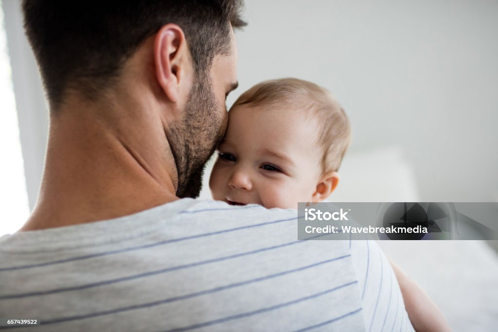 Father holding his baby girl Father holding his baby girl at home Father Stock Photo