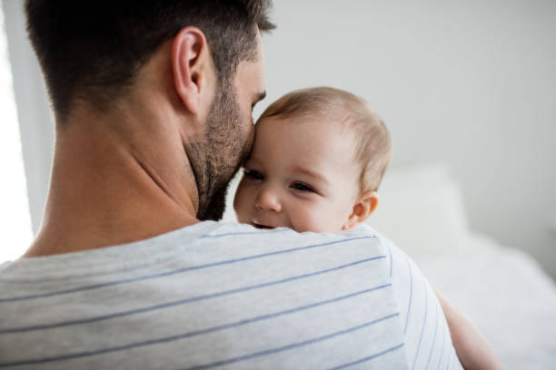 Father holding his baby girl Father holding his baby girl at home father stock pictures, royalty-free photos & images