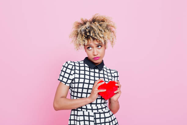 Woman holding a heart shaped valentines day card
