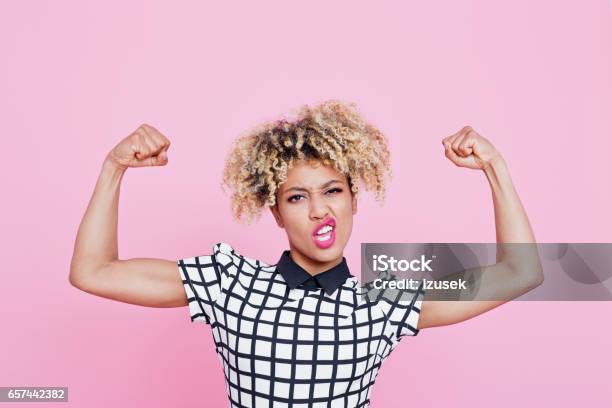 Strong Afro American Young Woman Flexing Muscles Stock Photo - Download Image Now - Women, Strength, One Woman Only