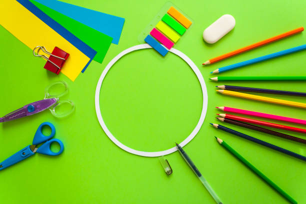 istock round frame with stationery flat lay on green background 657442684