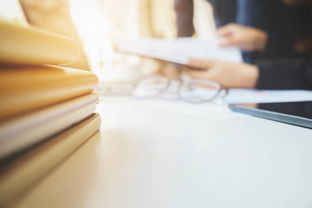 istock Business concept with copy space. Office desk table with pen focus and analysis chart, computer, notebook, cup of coffee on desk.Vintage tone Retro filter. 657449400