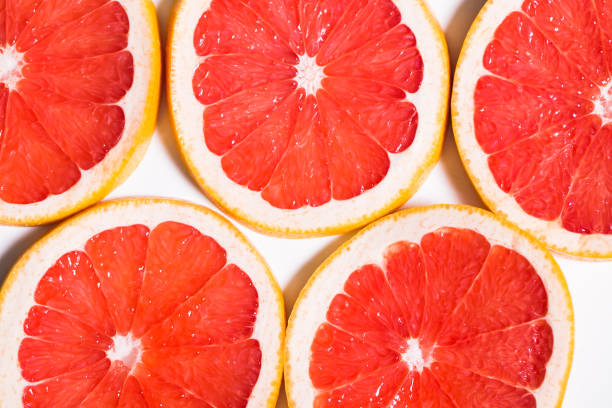 istock Texture of a ripe grapefruit slice, closeup 657449468