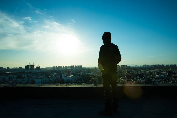 istock Young man looking city sunrise 657449616