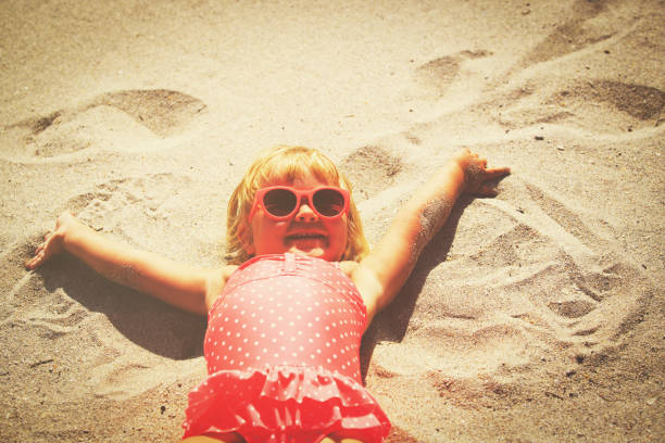 istock cute little girl play on summer beach 657457394