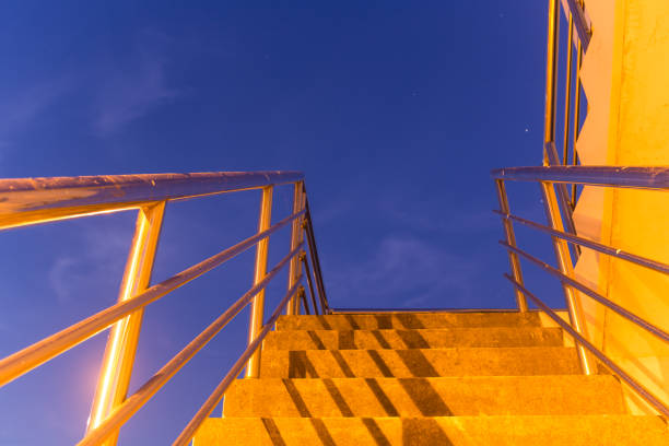 stair case toward to the roof under blue sky at night