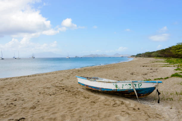 boat on the beach. the seaside is of sand, the sky is cloudy. Scene have melancholic mood and communicate quiet, the boat is light blue and white. pic are taken in Siculiana (Sicily).