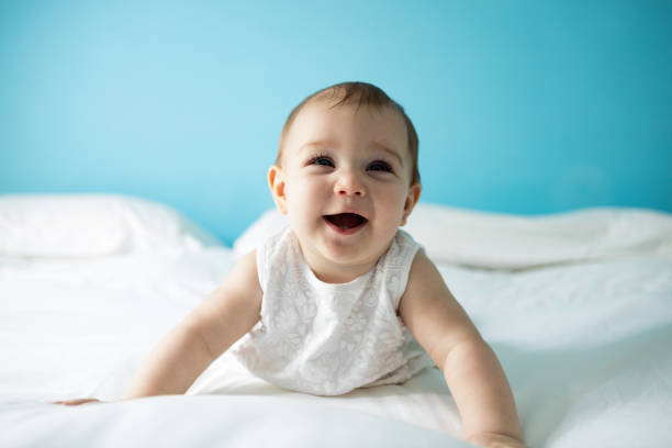 istock Cute smiling baby girl on bed 657463792