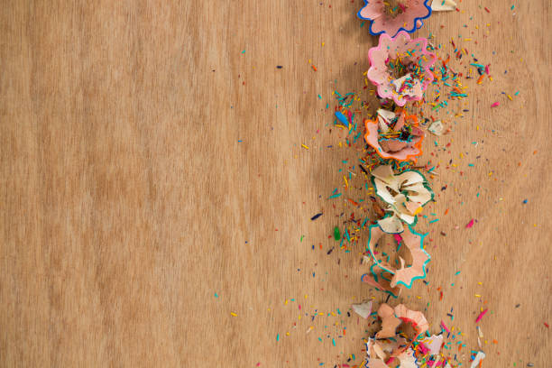 istock Colored pencil shavings on wooden background 657463966