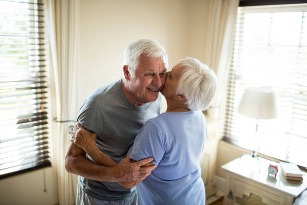 istock Senior couple embracing each other in bedroom 657464554