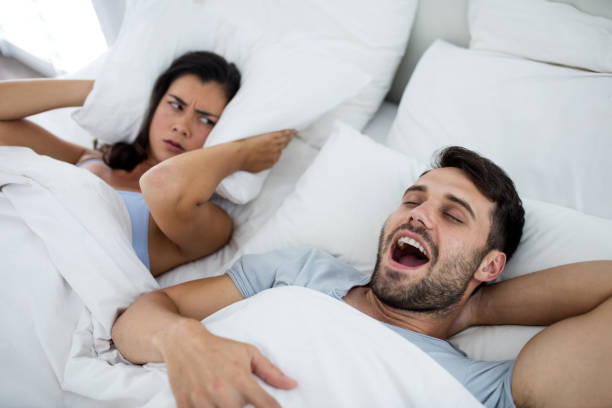 istock Woman getting disturbed with man snoring on bed 657464754