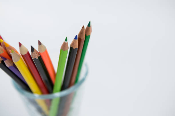 istock Colored pencils kept in glass on white background 657465102