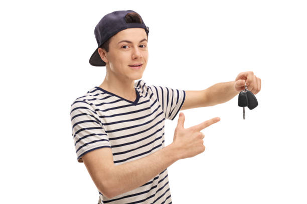 istock Teenager holding a car key and pointing 657477206