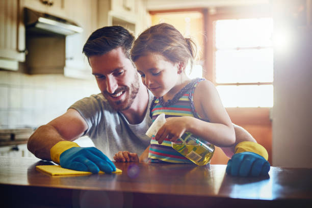 She's always willing to help Dad get the housework done Cropped shot of a father and his little daughter cleaning a kitchen surface together at home lens flare offspring daughter human age stock pictures, royalty-free photos & images