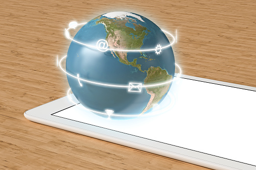 Globe with  app icons on tablet computer