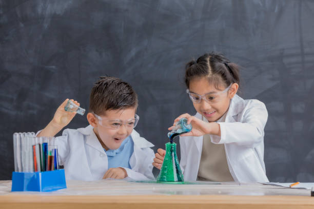 istock Happy STEM school kids in chemistry lab 657489726