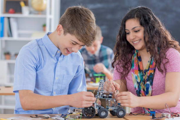 istock Male and female high school students in engineering class 657489856