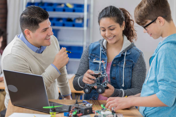 istock Male and female STEM school student build robot in tech class 657489870