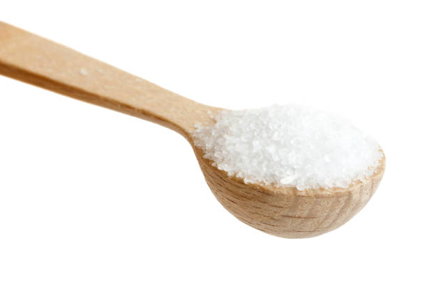 istock Small wooden spoon of fine salt isolated on white. 657496630