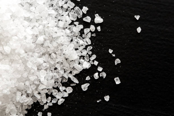 istock Heap of coarse salt on black from above. 657499096
