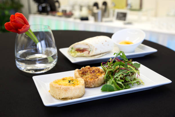 istock Two quiches and chicken tortilla wrap with dip on modern plates. 657499256