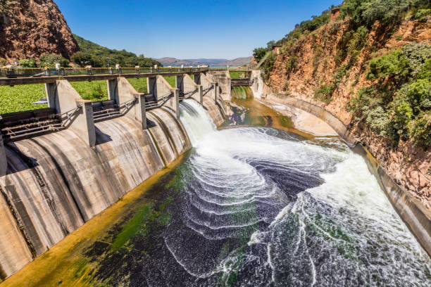 Hartbeespoort Dam reservoir wall with one open sluice gate and water gushing out into the crocodile river. This lake or dam offers many outdoor water sports to people from Johannesburg and Pretoria being only 30 minutes drive away.