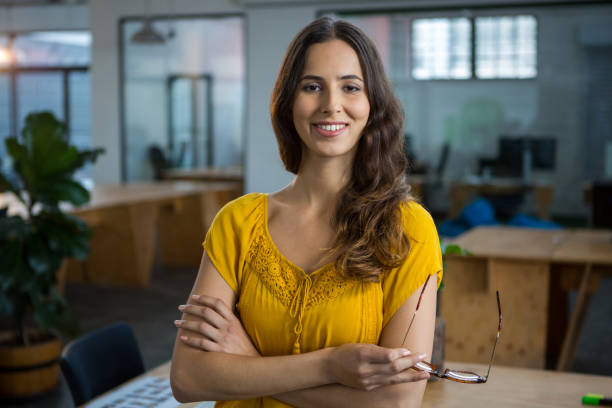 istock Female designer standing with arms crossed in creative office 657500248