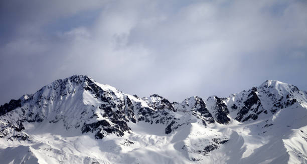 istock Panoramic view on sunlight winter mountains and sky with clouds 657510750
