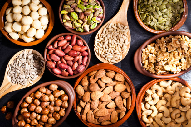 istock Assortment of nuts on rustic wood table. 657517170