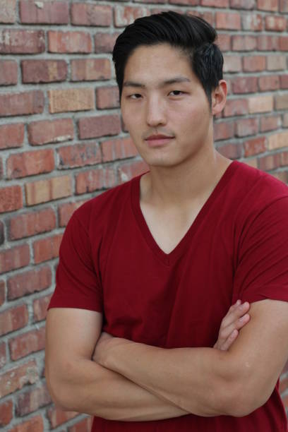 istock Asian man smiling with his arms crossed 657517544