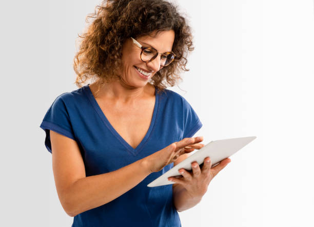 istock Happy woman working with a tablet 657525248