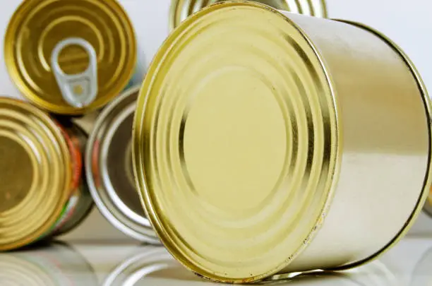 Canned food in tins on a light background.