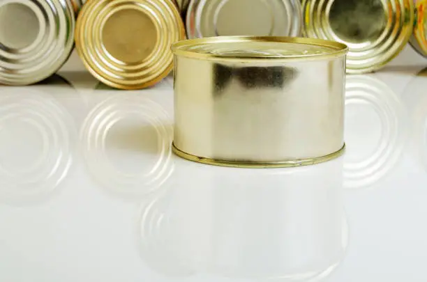 Canned food in tins on a light background.