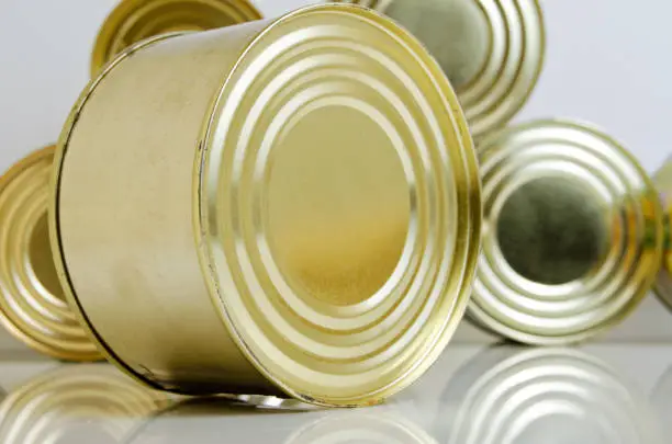 Canned food in tins on a light background.