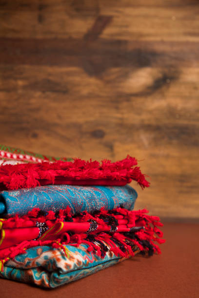 istock Stack of colorful scarves on wooden background. 657532954