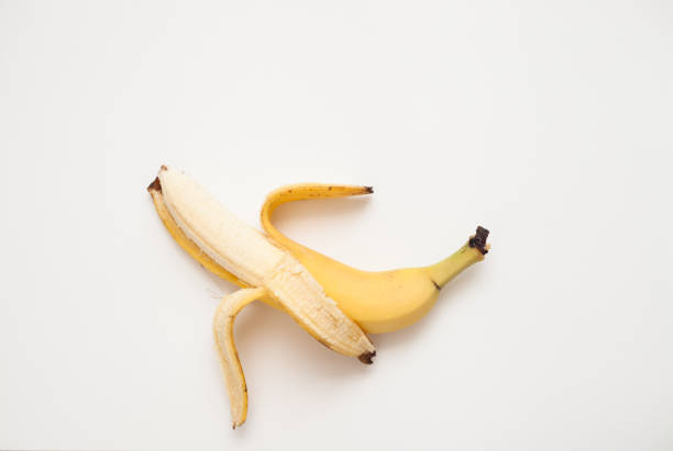 istock Half-peeled banana on a white background. 657533550