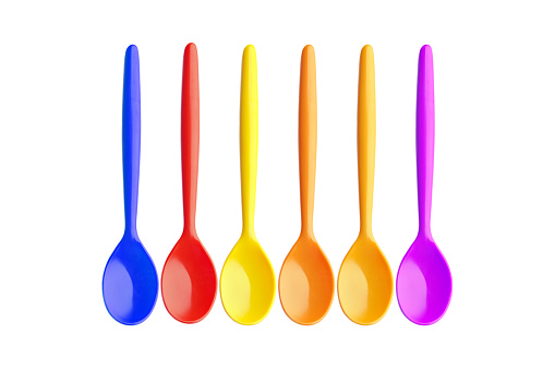 Group of multi colored egg spoons isolated on white