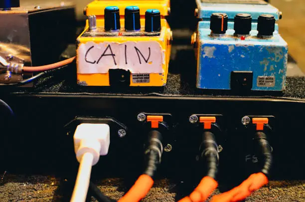 The power and cable end of a guitar pedalboard.
