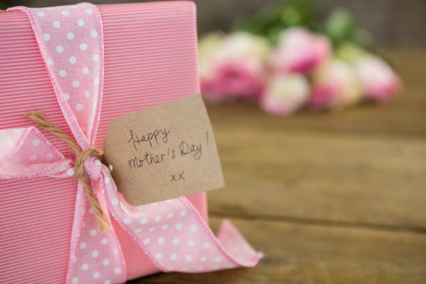 istock Gift box with happy mother day tag on wooden surface 657536382