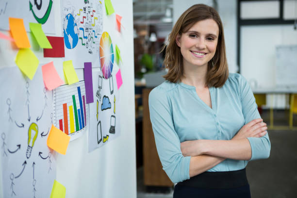 istock Female graphic designer standing with hands crossed in creative office 657537154