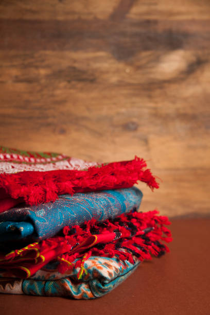 istock Stack of colorful scarves on wooden background. 657542174