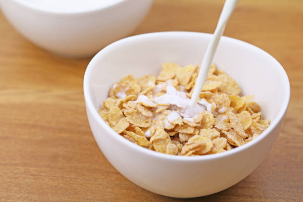 istock Milk with cornflakes into cereal bowls 657543036
