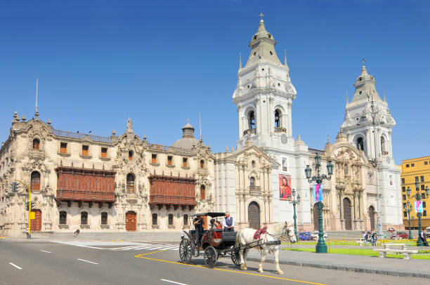 Balconies of colonial buildings with Iglesia La Compania de Jesus (Company of Jesus Church) in background.