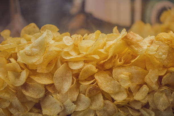 istock A lot of potatoes chips. Yellow salted potato chips as background. 657547550