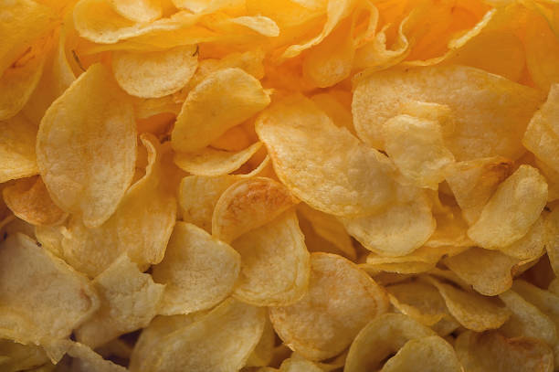 istock A lot of potatoes chips. Yellow salted potato chips as background. 657547554