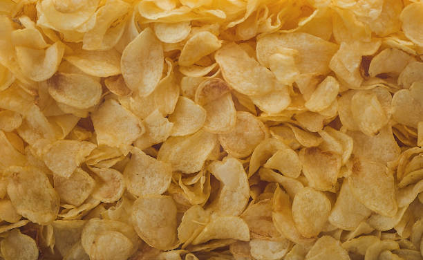 istock A lot of potatoes chips. Yellow salted potato chips as background. 657547586