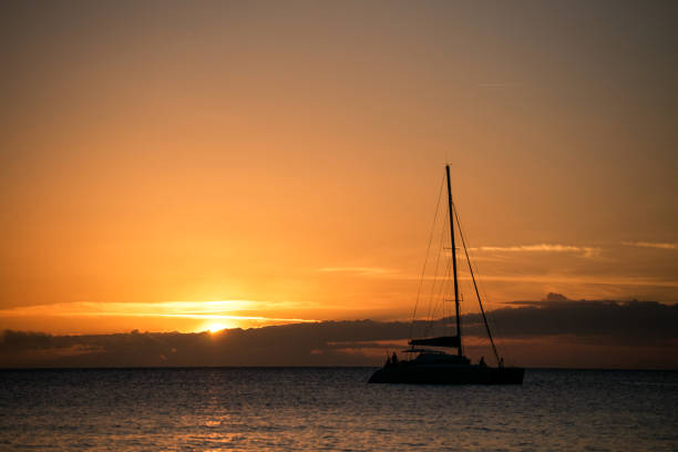 dominica sunset landscapes with  caribbean sea horizon and boat