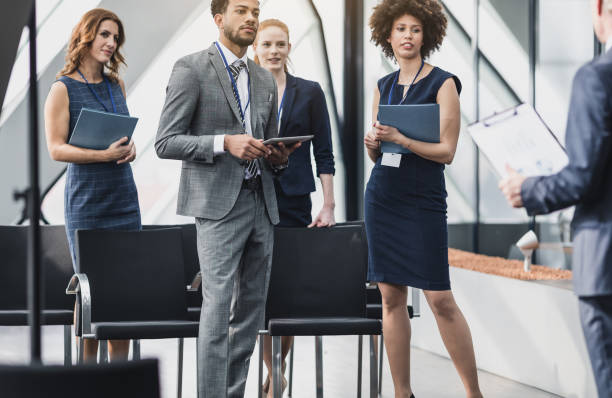 istock Group of Business People on a Conference Event Asking Questions 657547954