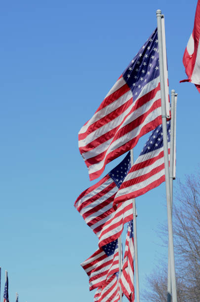 istock American flags in wind rippling on flag poles 657552770