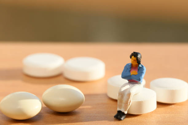 istock Women white tablets and miniature 657558096